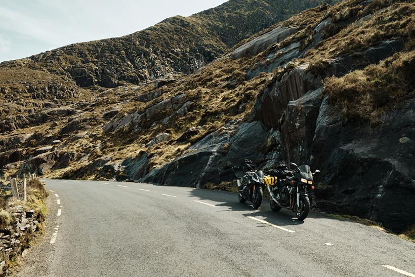 Motorcycles parked by side of road in Ireland