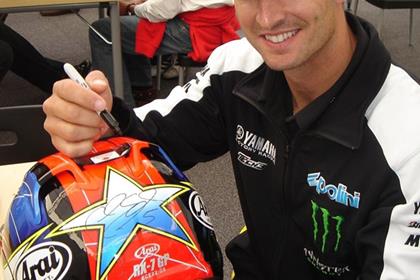 Colin Edwards signs his replica Arai RX7-GP