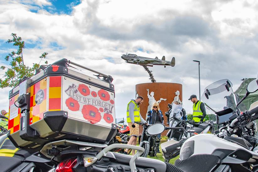 Motorcycles parked in front of the Bomber Command statue