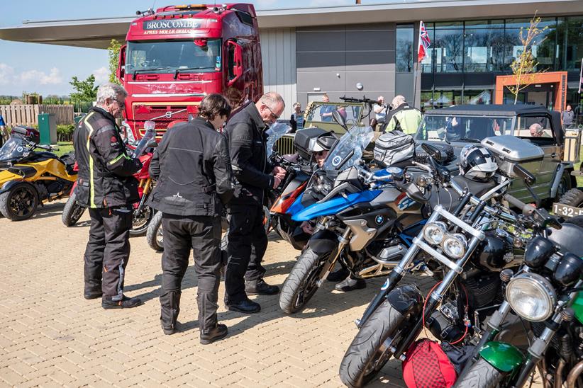 Bikes parked up with riders inspecting them