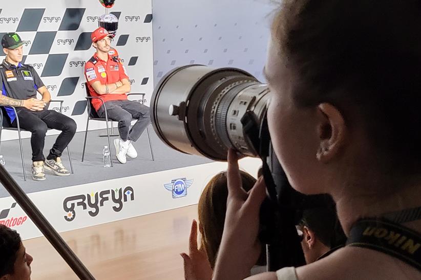 A Click Diversity candidate taking photos in a MotoGP press conference