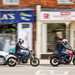 2024 Triumph Speed 400 and Royal Enfield 350 - riding past camera on high street