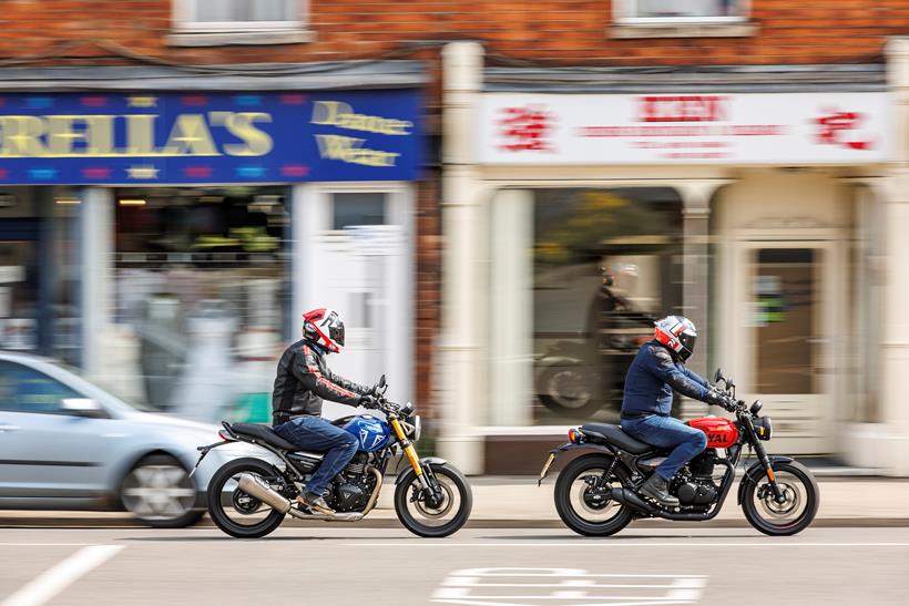 2024 Triumph Speed 400 and Royal Enfield 350 - riding past camera on high street 