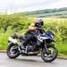 2024 BMW F800GS riding past a hedgerow