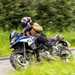 2024 BMW F800GS riding past a green field