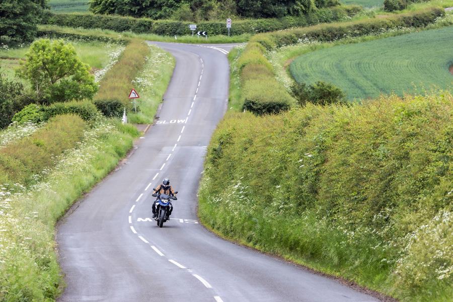 2024 BMW F800GS riding down a country road