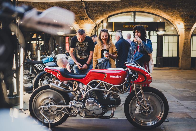 Visitors look at a Ducati custom motorcycle