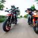 2024 Ducati Hypermotard 698 Mono RVE and KTM 690 SMC R riding on the road towards the camera