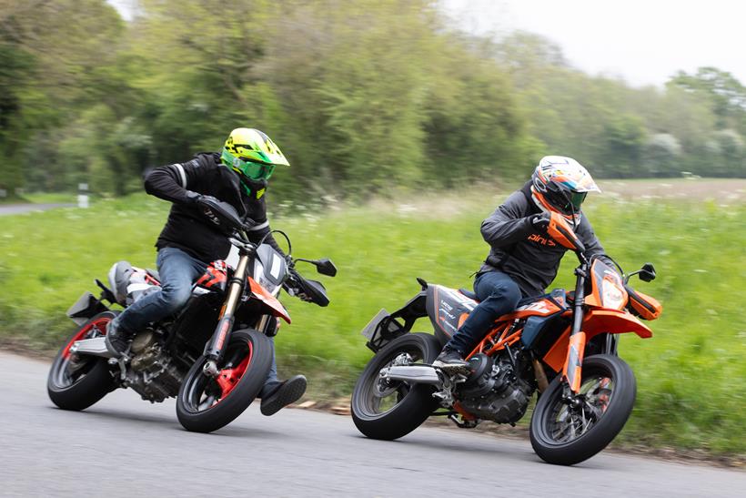 2024 Ducati Hypermotard 698 Mono RVE and the KTM 690 riding together round a corner 