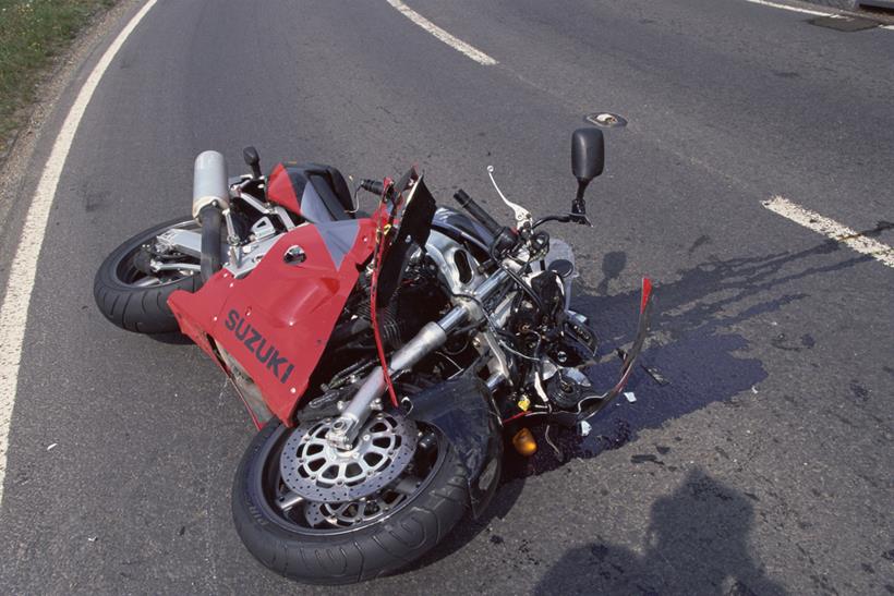 Crash damaged Suzuki lays on its side