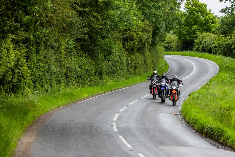 Our trio of hardcore adventure bikes on a long, winding road