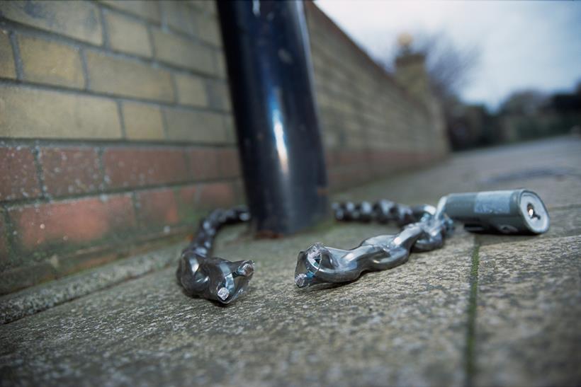 A cut security chain, wrapped around a post