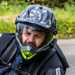 Cardo Packtalk Pro on side of helmet while riding