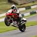 Classic Honda rider wheelieing over the Mountain at Cadwell