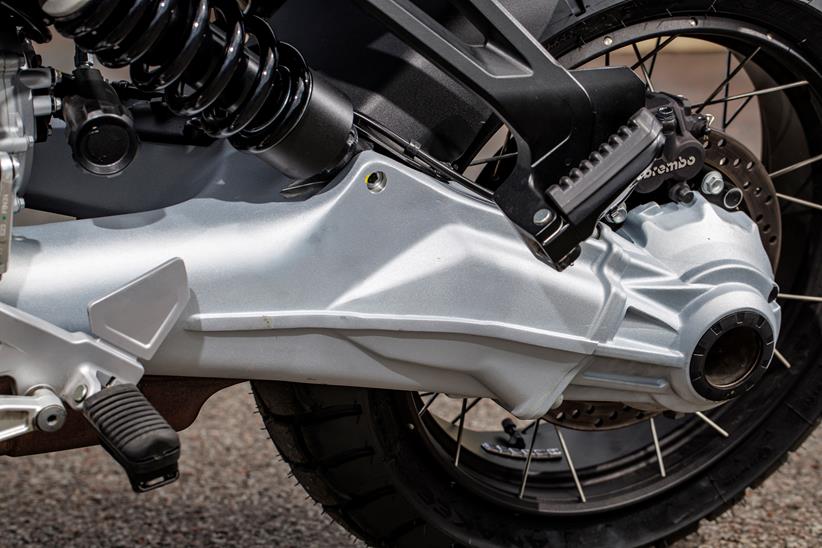 A close up the 2024 Moto Guzzi Stelvio's shaft drive swing arm and tyres