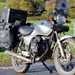 The silver Honda CG125 with touring gear