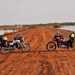 Honda CG125s parked up on a dirt track