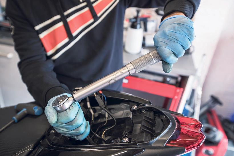 Doing maintenance on a motorbike