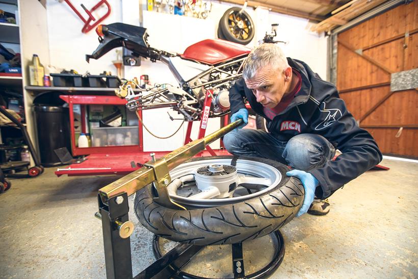 Bruce Dunn using a bead breaker tool