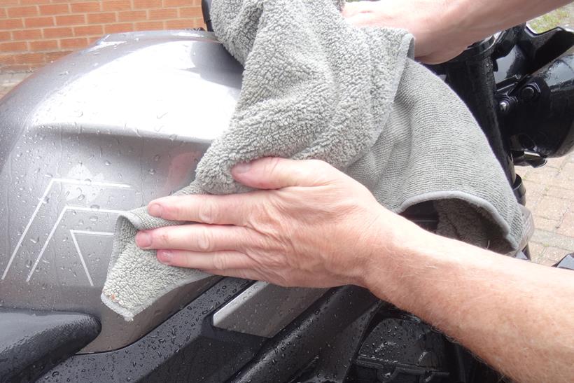 Drying a motorcycle with a cloth