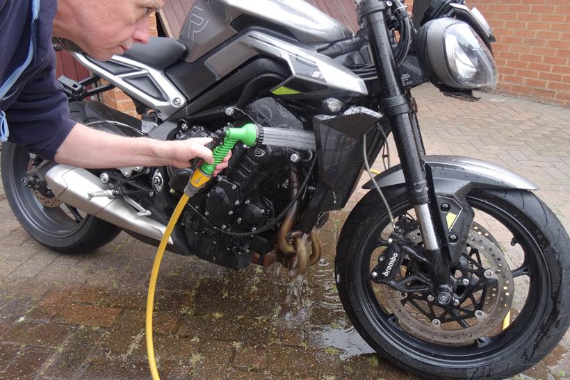 Rinsing a motorcycle radiator with a hose