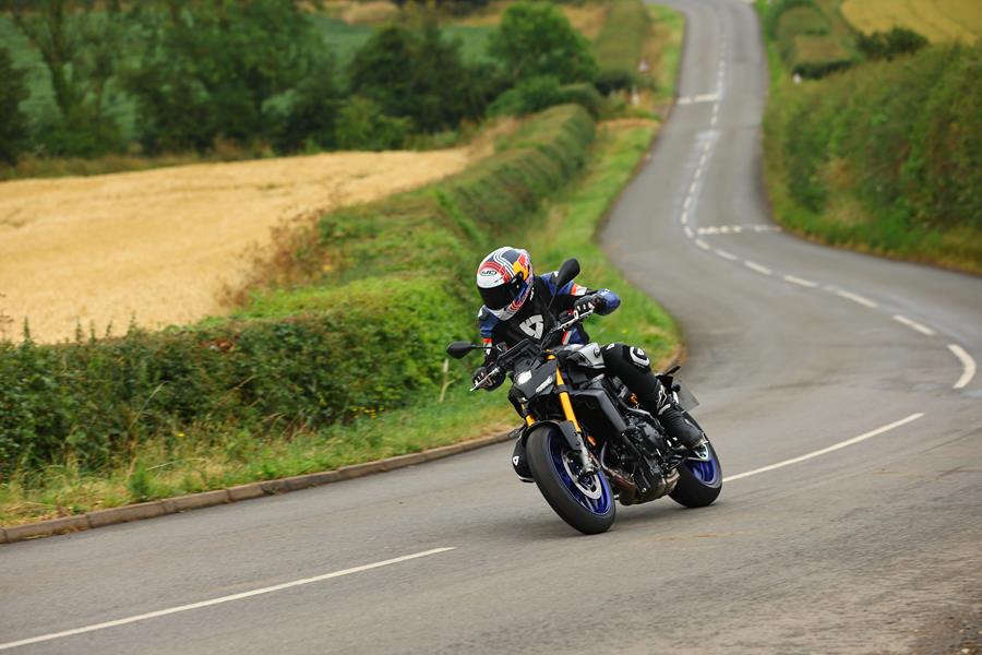 2024 Yamaha MT-09 SP riding through a curvy country road