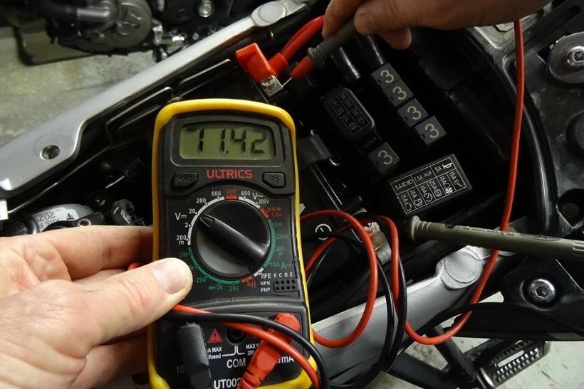 Checking motorcycle battery with a multimeter