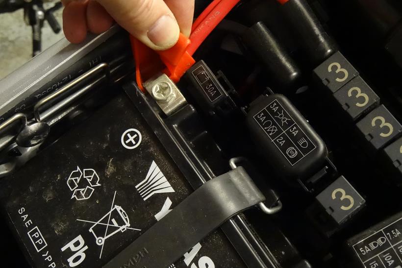 Expose the battery's terminals if necessary