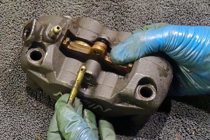 Removing a brake pad pin from the caliper