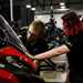 Superbike Factory Apprentice with instructor looking at bike