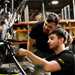 Superbike Factory Apprentice with instructor looking at bike