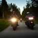 Harley-Davidson riders on the road at dusk