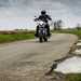 Motorcyclist on road with potholes to side