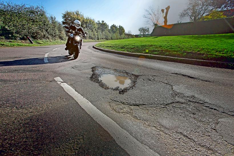 Motorcyclist approaching pothole