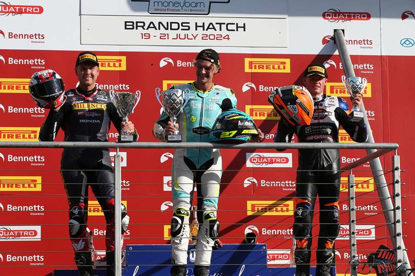 Tom Ward celebrates on the podium after winning at Brands Hatch.