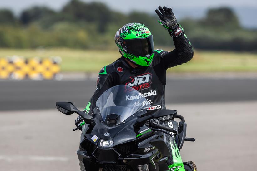 Jonny Davies waves at the crowd after his successful record run