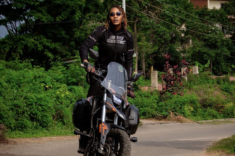 Udoh Ebaide Joy stood up on her motorcycle