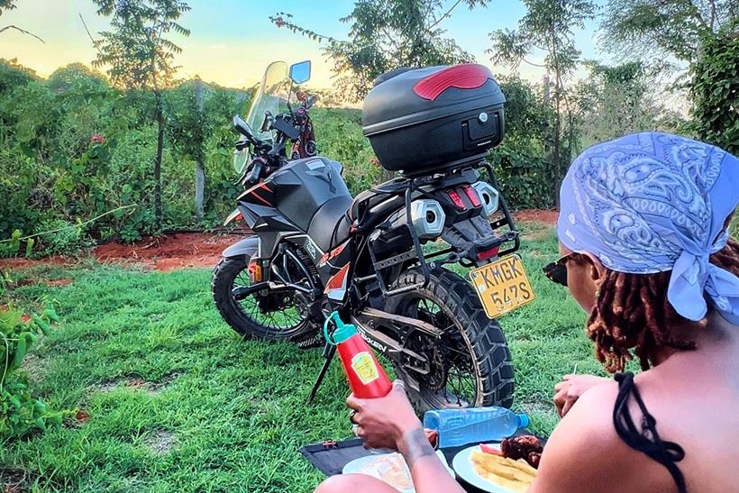 Udoh Ebaide Joy eating with sunset backdrop