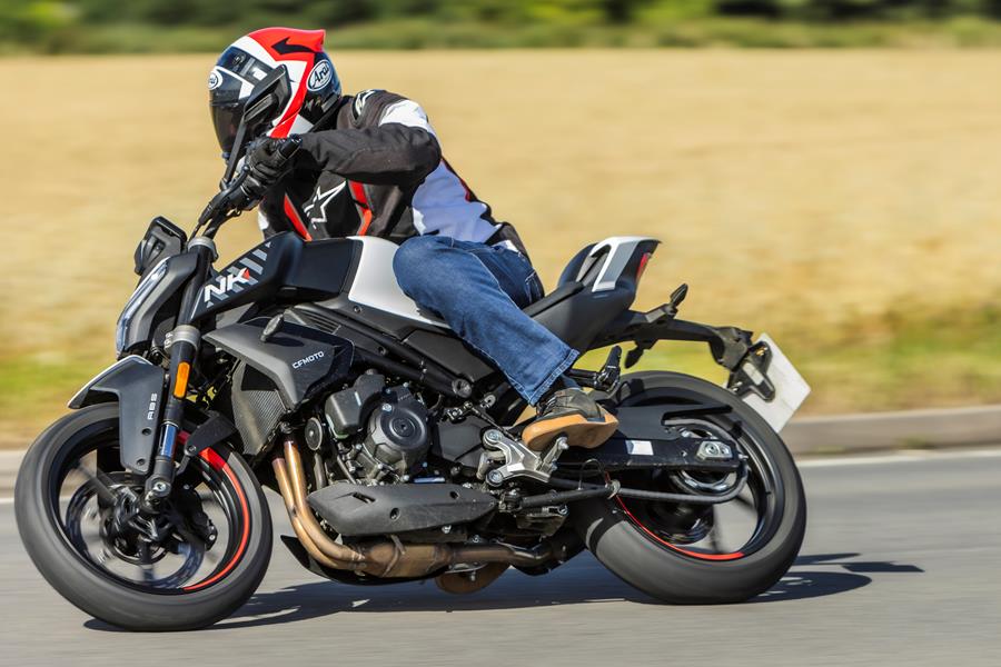 2024-on CFMoto 450NK riding into a right turn on a country road