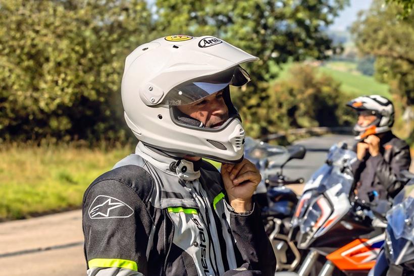 Michael Neeves puts on an Arai Tour-X 4 helmet