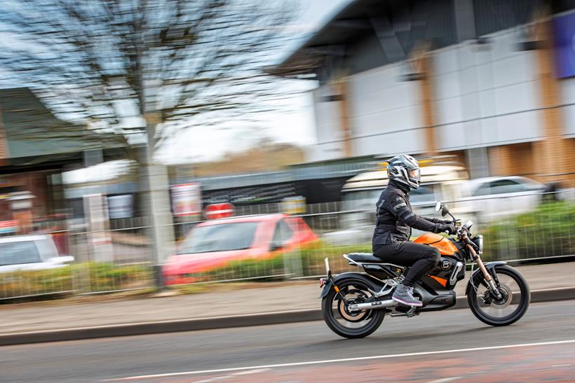 Urban motorcyclist riding through town