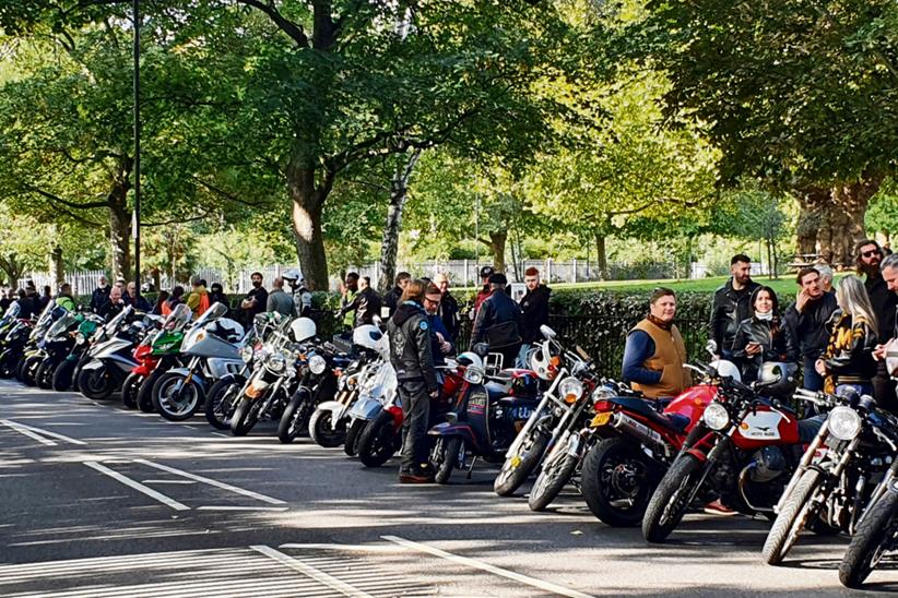 Motorcyclists lined up at side of road