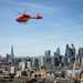 Air Ambulance helicopter in the air above London skyline