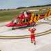 Two people walk towards Air Ambulance helicopter