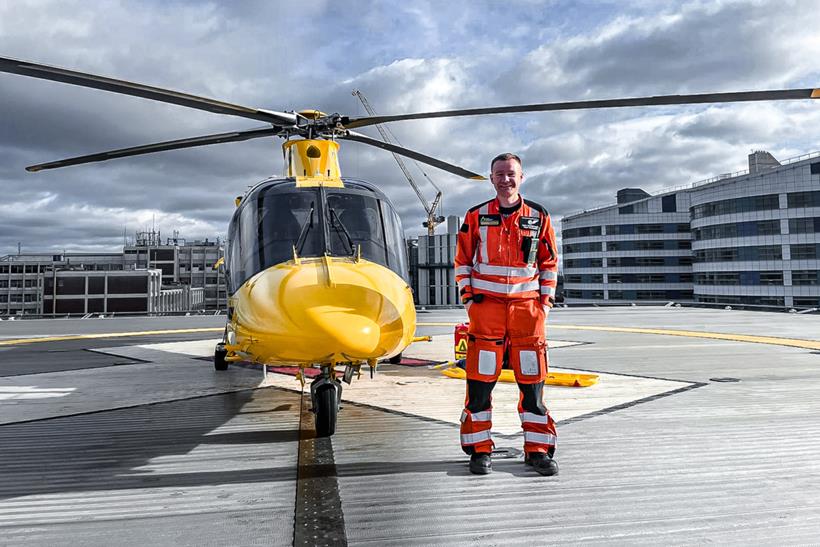 Man standing next to helicopter