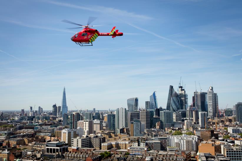 Air Ambulance helicopter in the air above London skyline