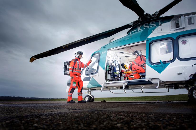 Air Ambulance team standing in and out of the helicopter