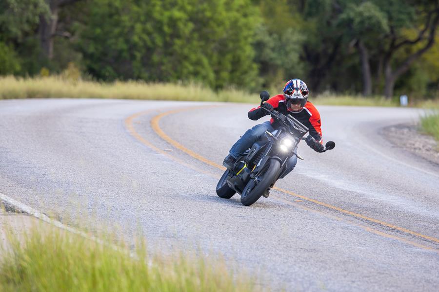 2025-on Can-Am Pulse cruising down a curved road