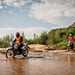 Riders for Health riders crossing river