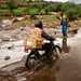 Riders for Health rider crossing river